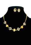 Gold plated necklace and earring set featuring transparent glass stones and raw pearl. Handcrafted statement jewellery.
