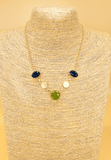Gold plated necklace featuring light green and blue semi precious stones. Handcrafted statement jewellery.