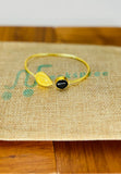 Gold plated adjustable handcuff with black stone. Handcrafted statement jewellery.