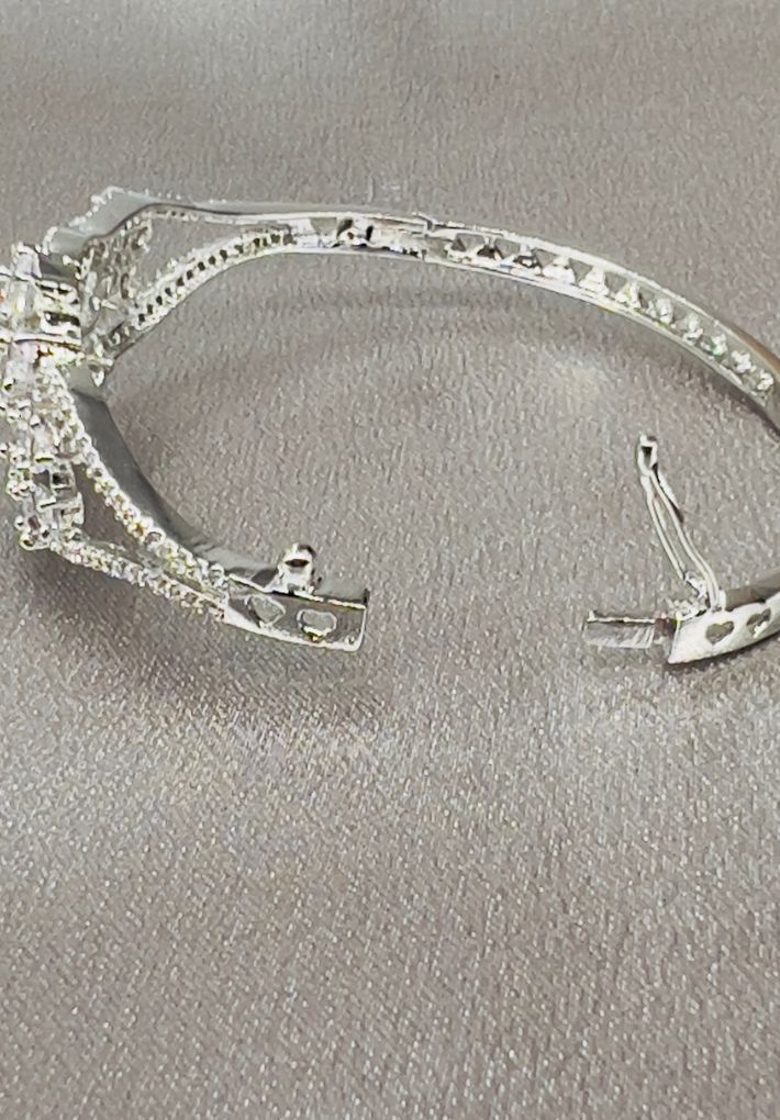 Snap fit bangle featuring American diamonds and hydro stones.