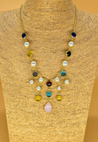 Gold plated necklace featuring multi colored semi precious stones and pearls. Handcrafted statement jewellery.