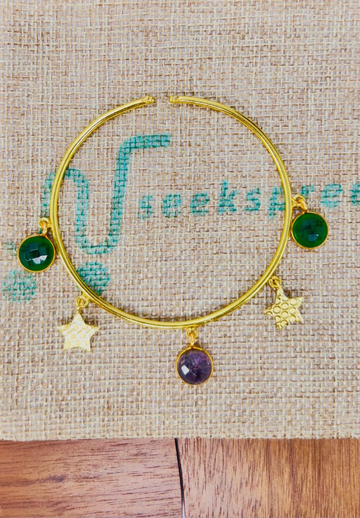 Gold plated adjustable handcuff with multi color stones. Handcrafted statement jewellery.