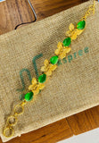 Gold plated adjustable bracelet with green stones. Handcrafted statement jewellery.