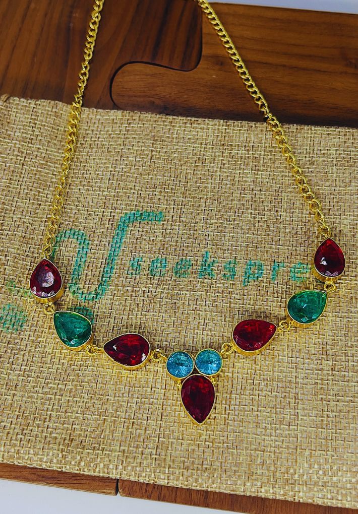 Gold plated necklace featuring multicolored stones. Handcrafted statement jewellery.