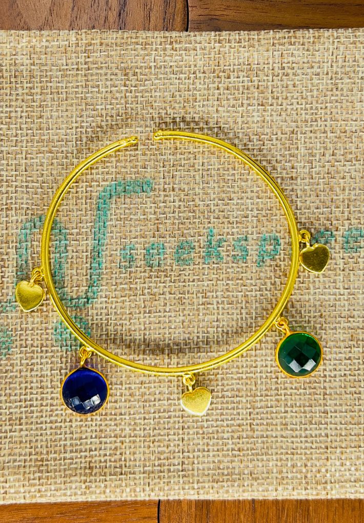 Gold plated adjustable handcuff with multi color stones. Handcrafted statement jewellery.