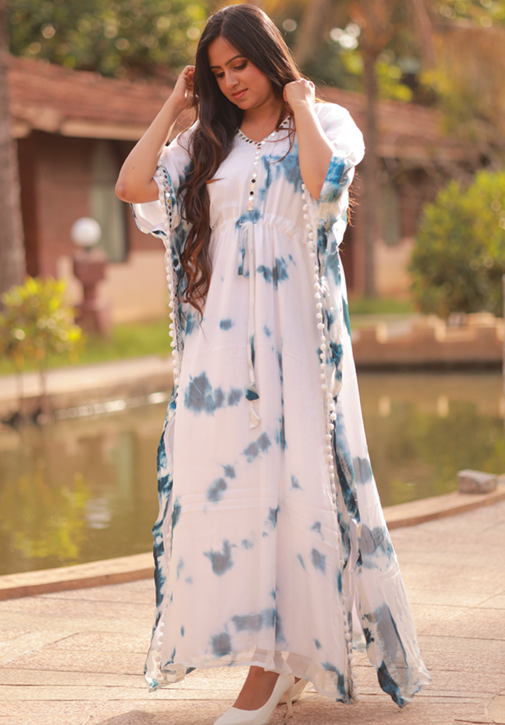 Beautiful white kaftan with blue prints in georgette with mirror work, gather detail and pompom detail
