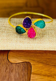 Gold plated adjustable bangle with multicolored druzy stones.