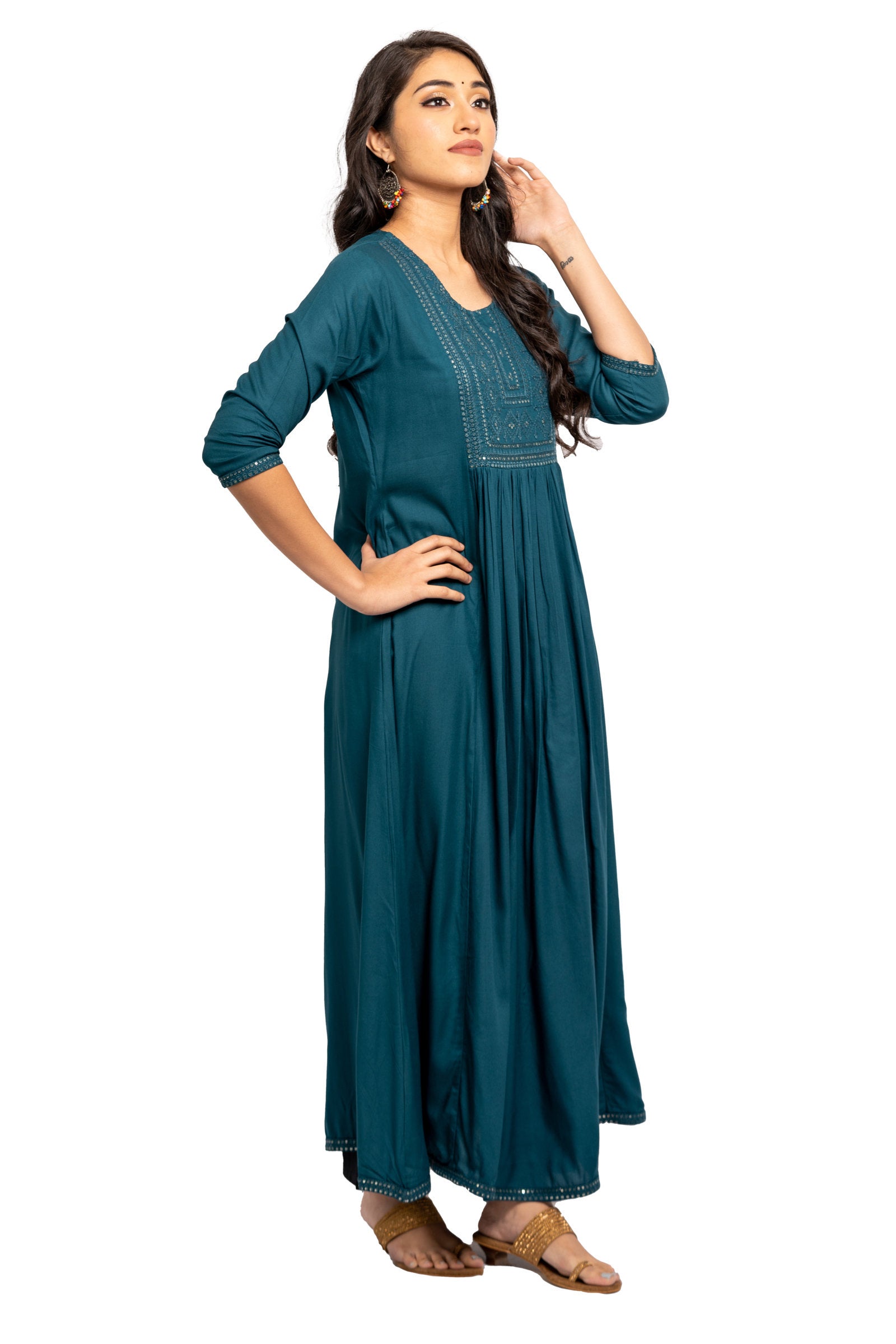 Full Gown - Blue full gown with rich embroidery in the front and gather detail. 3/4th Sleeve with matching embroidery at the tip. Round neck. Flared hemline deriving from the gather detail with matching embroidery. Rayon material.